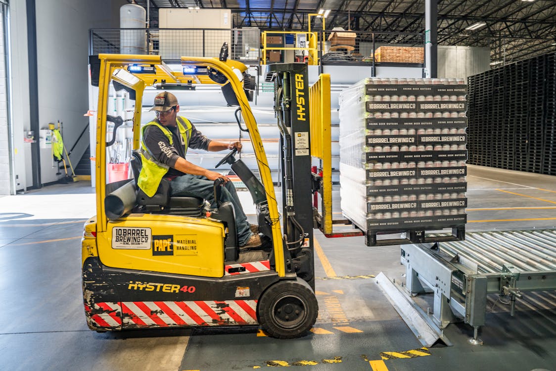 An image of a person using a forklift inside a distribution center    