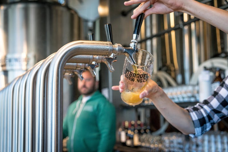 Friends raising glasses together inside the Ironside Brewing Co. taproom