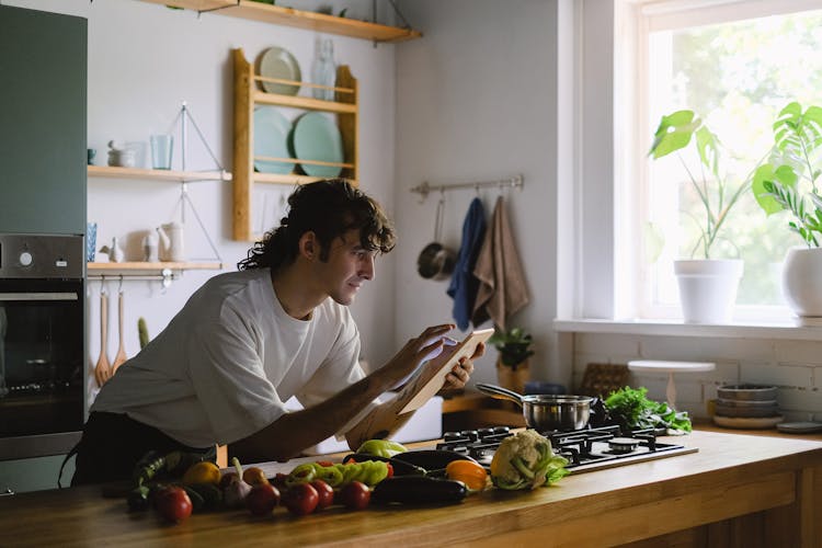 Man Using A Tablet In A Kitchen