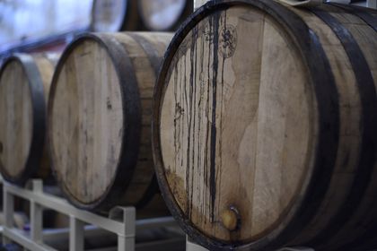Cask heads stacked close in a cellar — photo by ELEVATE on Pexels