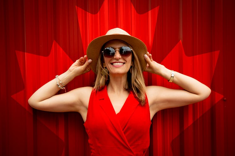 Woman In Red Sleeveless Dress With Canada Flag Printed Background