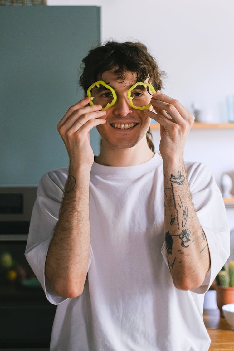 Man In White Shirt Holding Green Vegetable