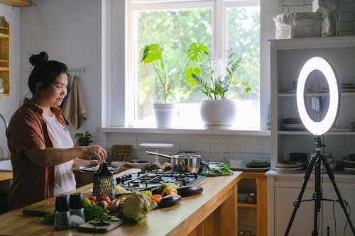 Woman in White Shirt Standing in Front of Kitchen Island