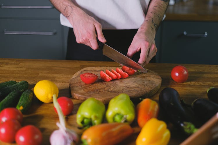 A Person Slicing Tomatoes