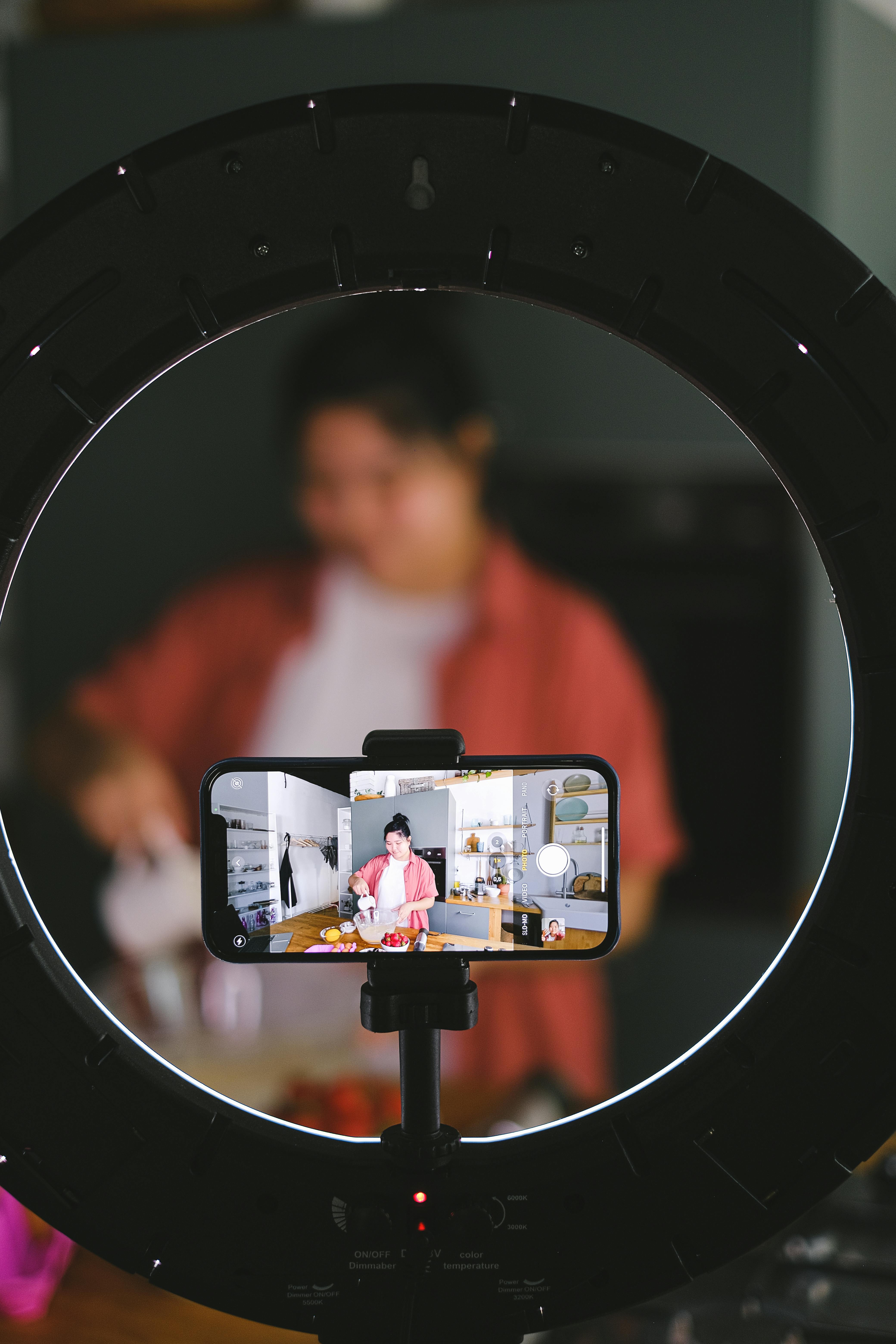 Phone on a tripod recording a woman cooking