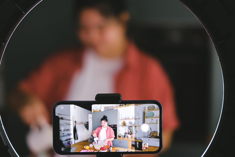 Phone mounted on a tripod filming a product close up