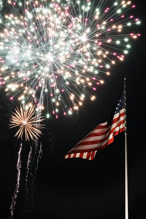 American Flag and Fireworks Display during Night Time