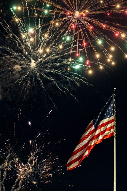 Free Stunning night display of fireworks with an American flag in New York City. Stock Photo