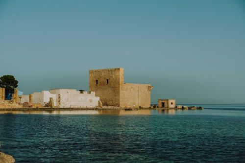 Free Historic coastal fort beside tranquil sea with clear skies, perfect for travel imagery. Stock Photo