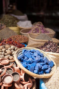 Explore the colorful spices and merchandise at a bustling Moroccan market in Marrakech.