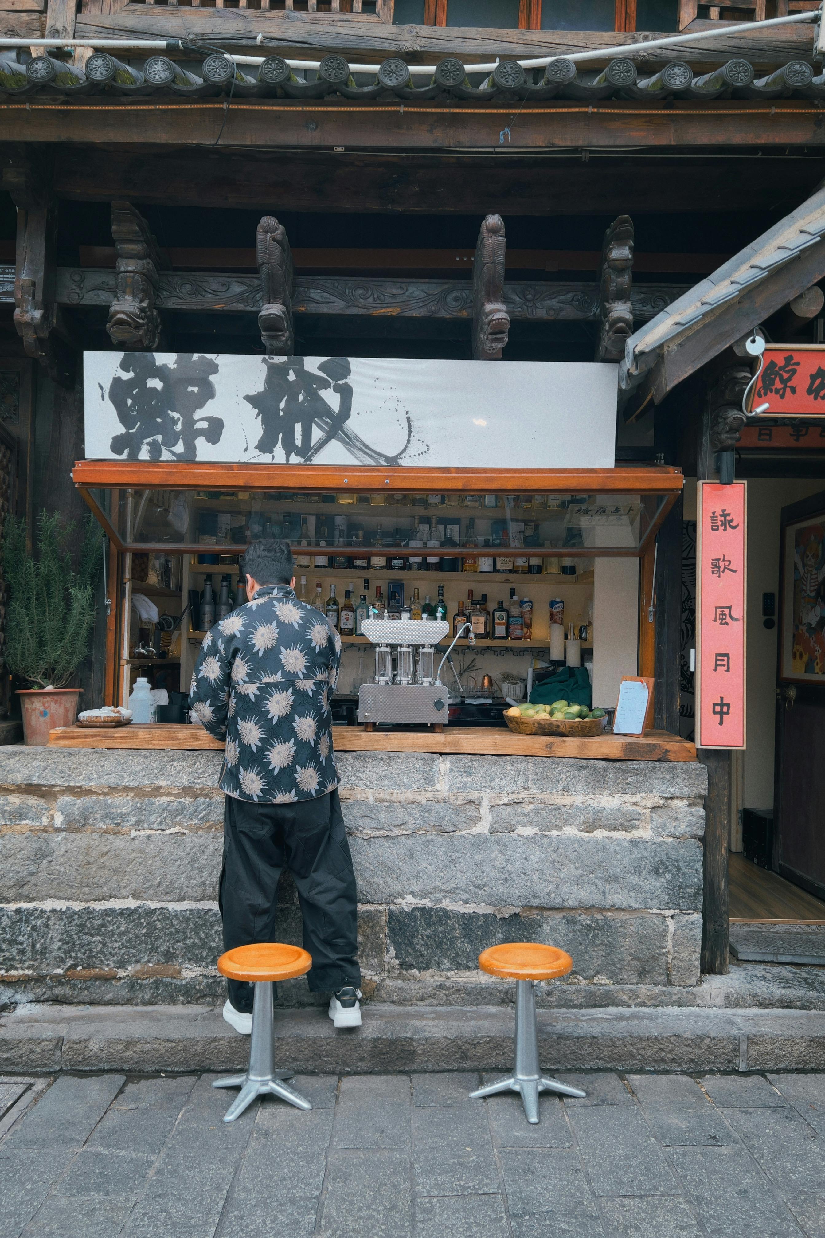 Man Standing a Food Stall