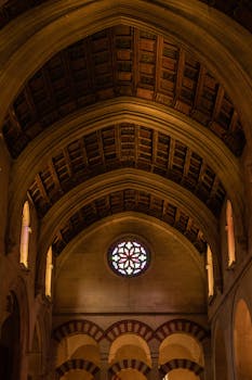 Detailed view of the Mosque-Cathedral of Córdoba's iconic arches and stained glass.