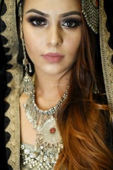 Close-up portrait of a beautiful woman wearing traditional clothing and jewelry.