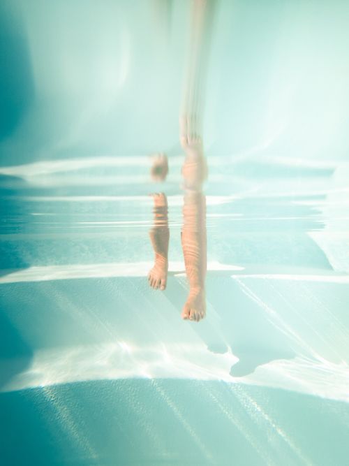 Free A unique underwater photo capturing the reflection of legs in a swimming pool in Los Angeles. Stock Photo
