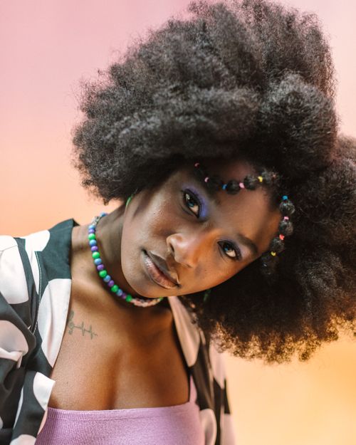 Free Fashionable portrait of a woman with afro hairstyle and colorful beads in Brazil, Indiana. Stock Photo