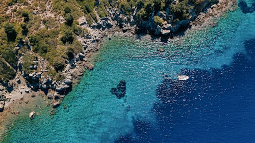 Aerial Shot of White Boat Sailing on the Blue Ocean 