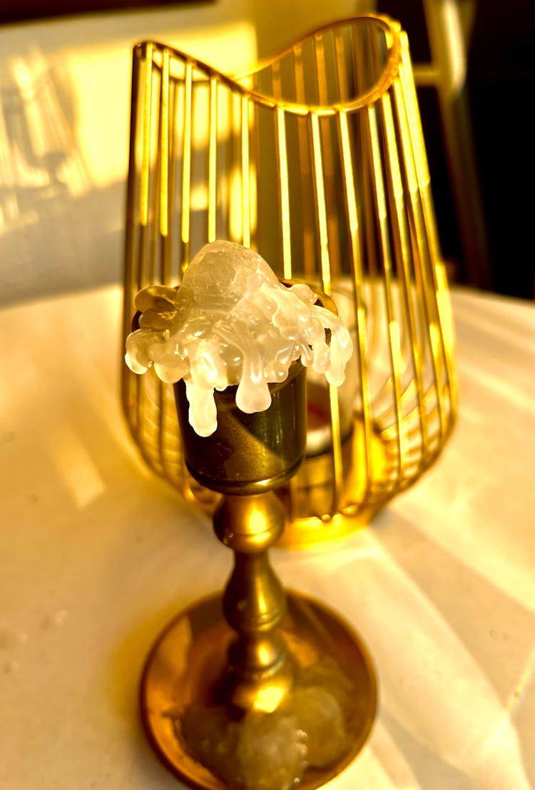 A Melted Candle On A Candle Holder