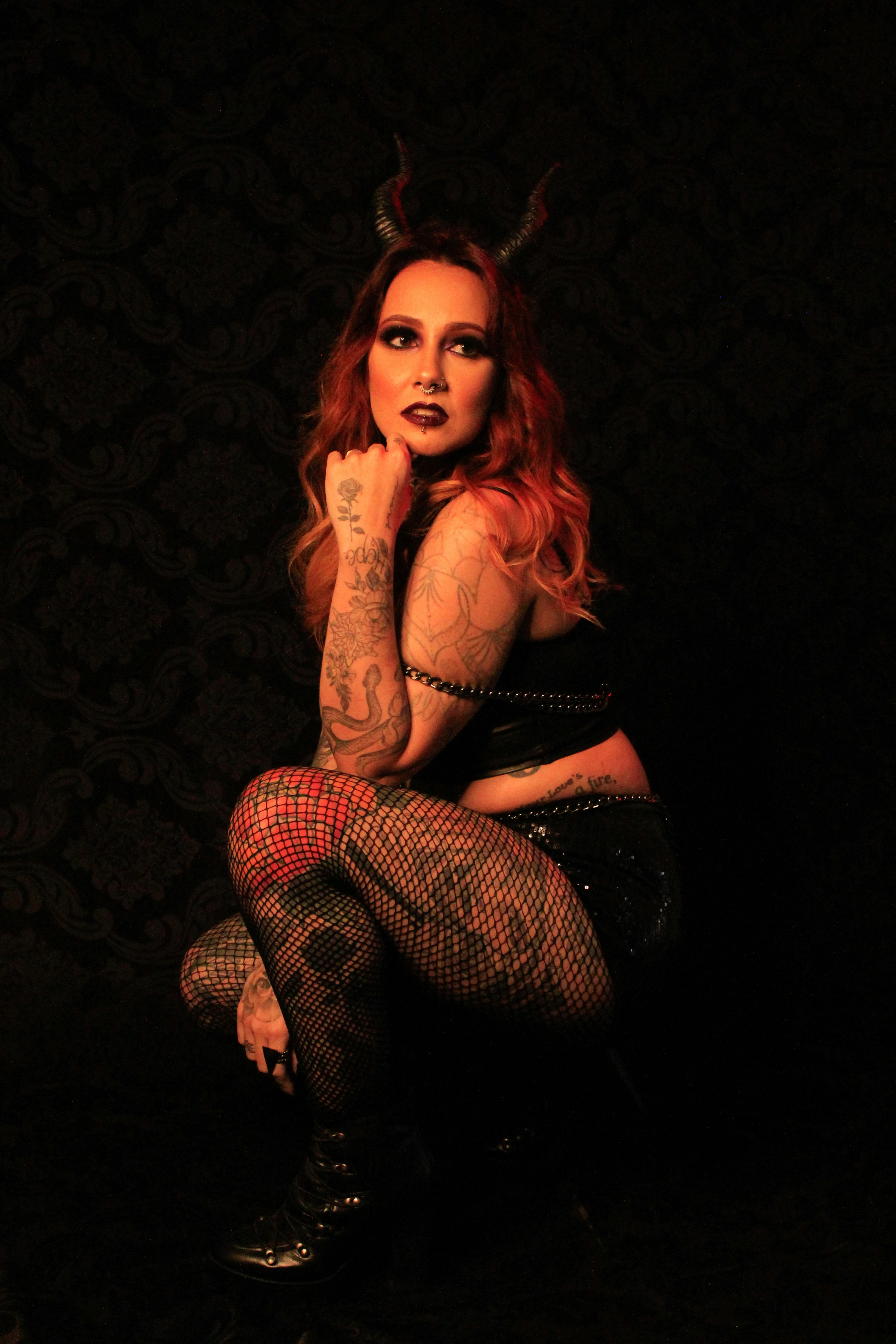 A Tattooed Woman Wearing Fishnet Stockings Free Stock Photo   Pexels Photo 12676547 