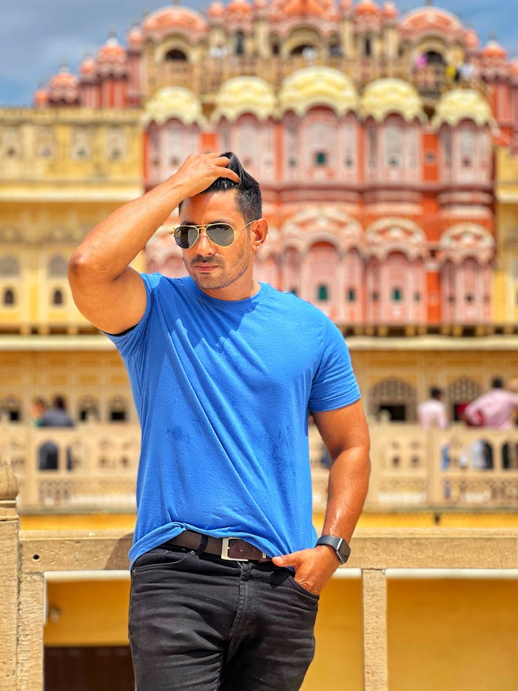 Man In Sunglasses Posing Near Traditional Building