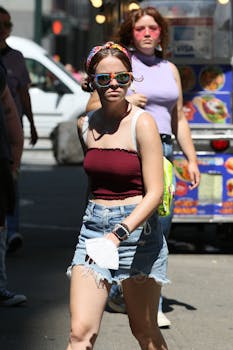 Two women in stylish outfits enjoying a sunny day. Perfect for lifestyle and fashion themes.