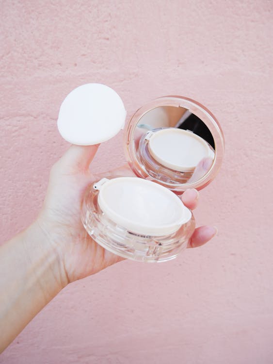 Free Hand Holding a Powder Box Stock Photo
