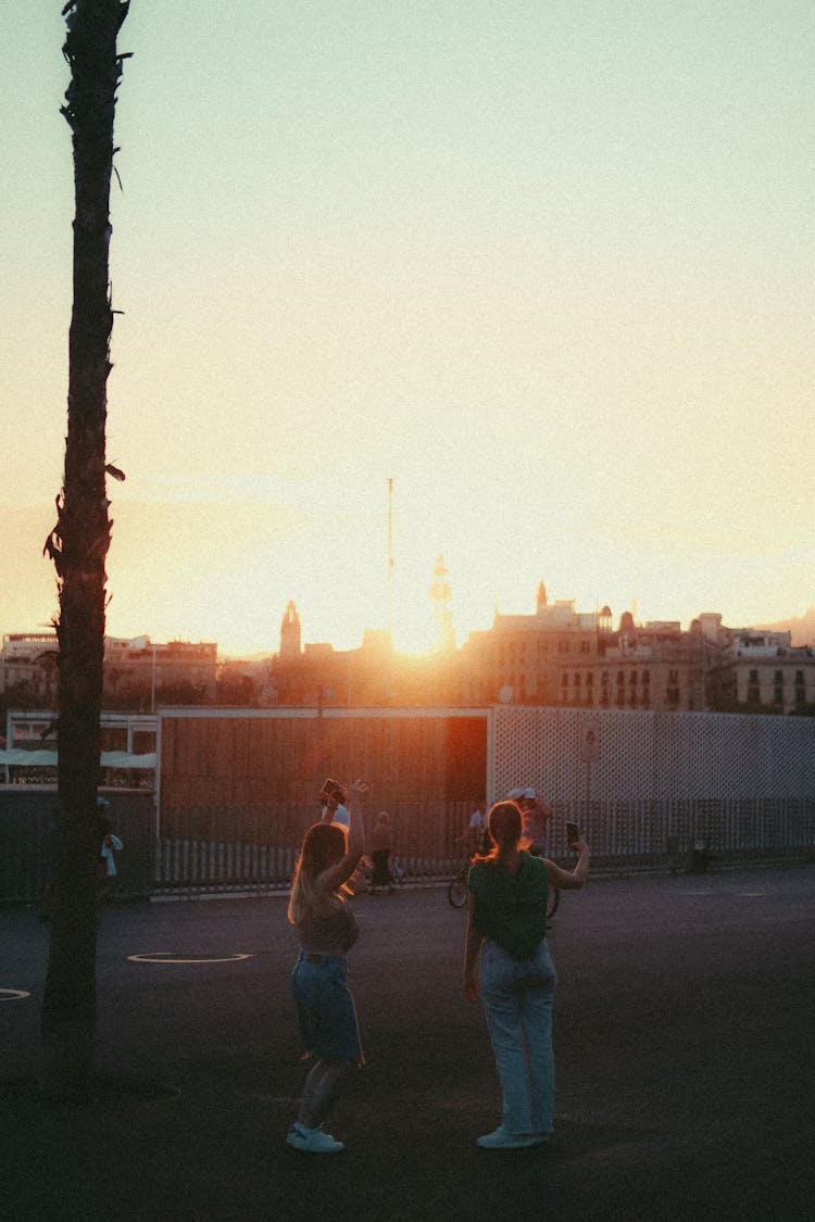 Busy Women Standing On The Street During Sunset