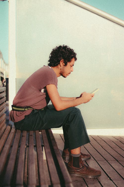 Man Sitting on Wooden Bench