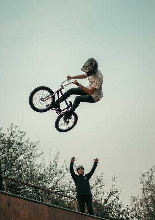 Free Thrilling BMX stunt captured mid-air with clear sky backdrop in Chile. Stock Photo
