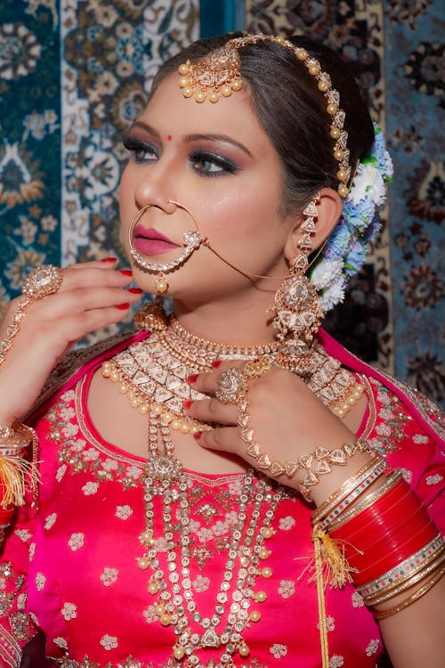 Woman in Red and Gold Top Wearing Jewelries