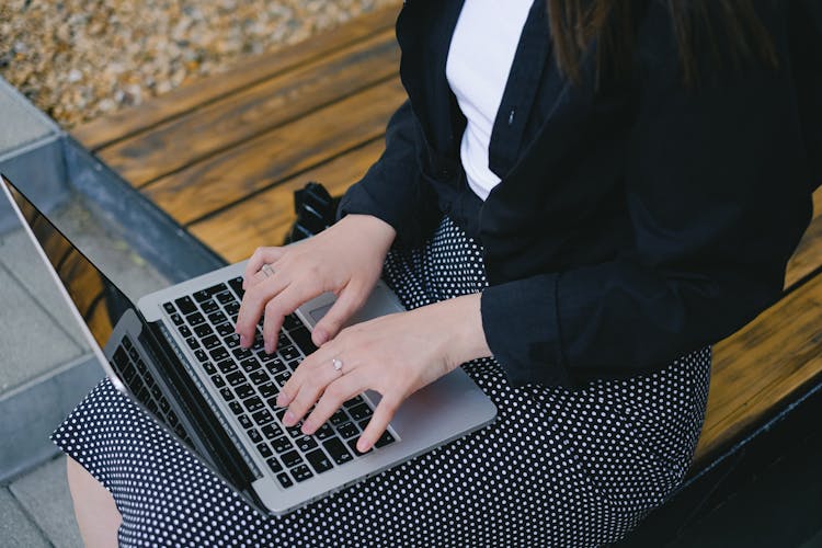 Woman Typing On Laptop