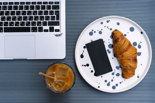 Bread on White Ceramic Plate Beside Macbook Pro