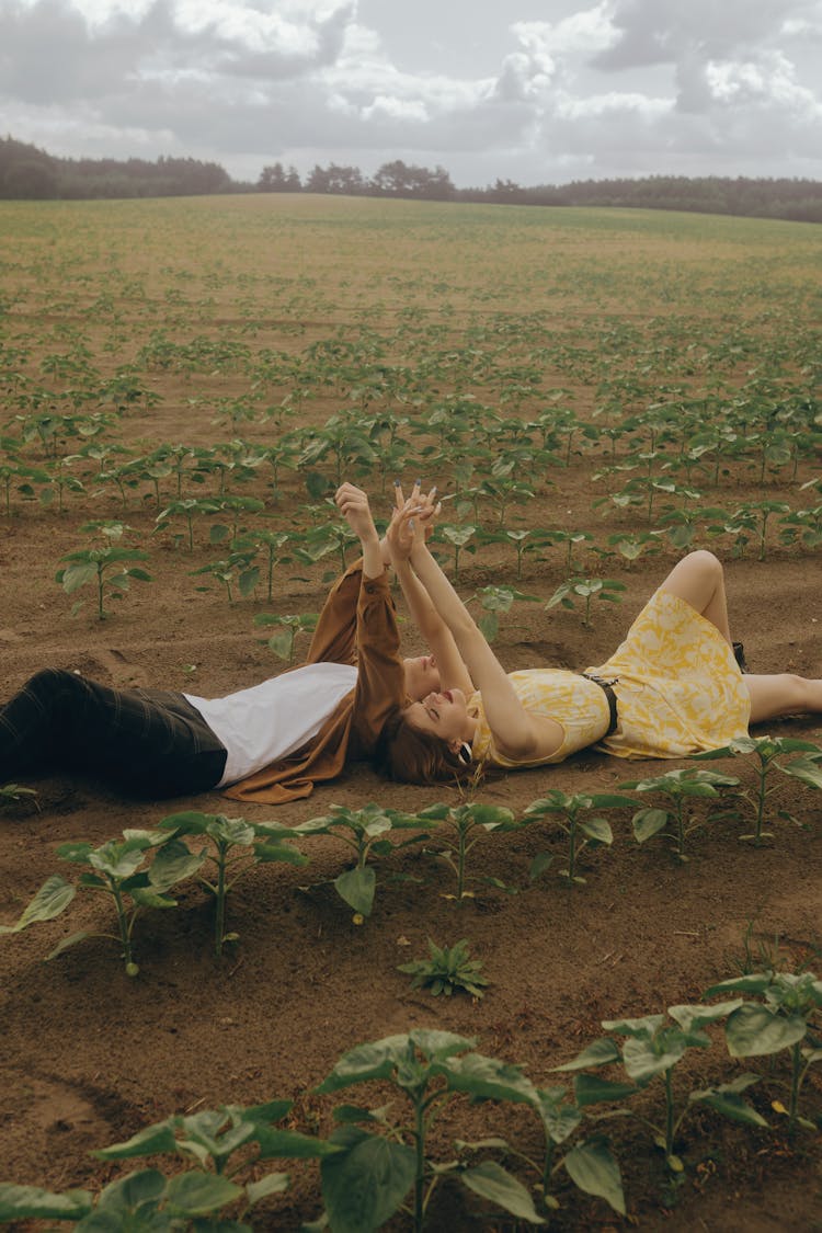 Couple Lying On A Field 