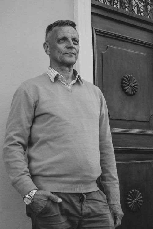 Free Monochrome portrait of a mature man standing outdoors, exuding confidence. Stock Photo