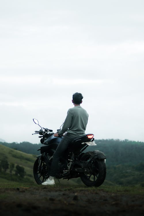 Free Man in Gray Shirt Sitting on Black Motorcycle Stock Photo