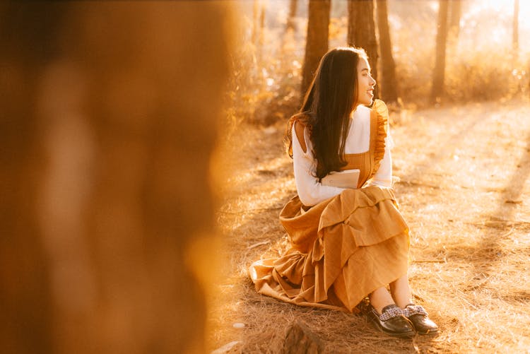 Woman Sitting On The Ground