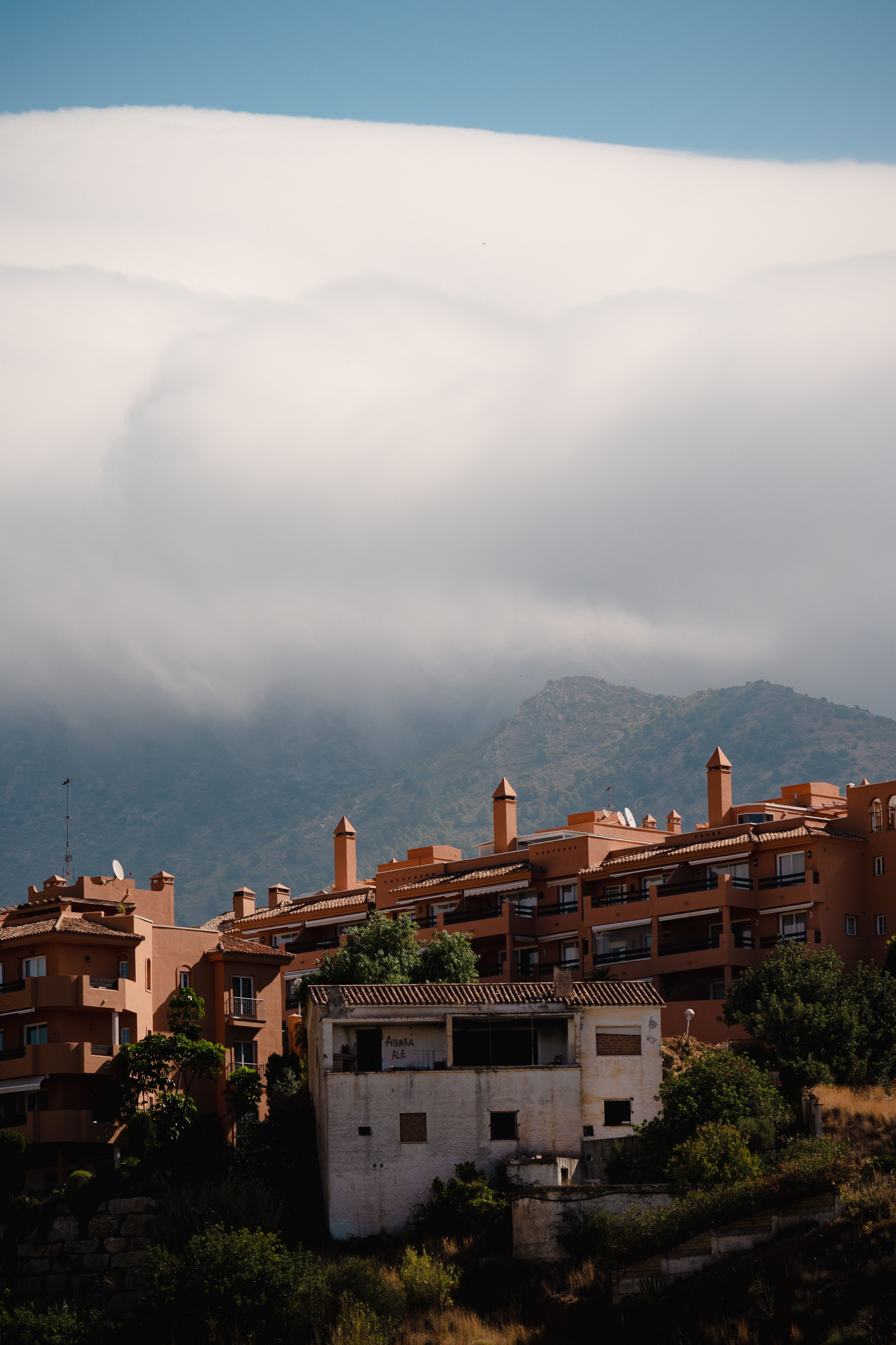 Charming residential buildings in Fuengirola, Spain with scenic mountain backdrop.