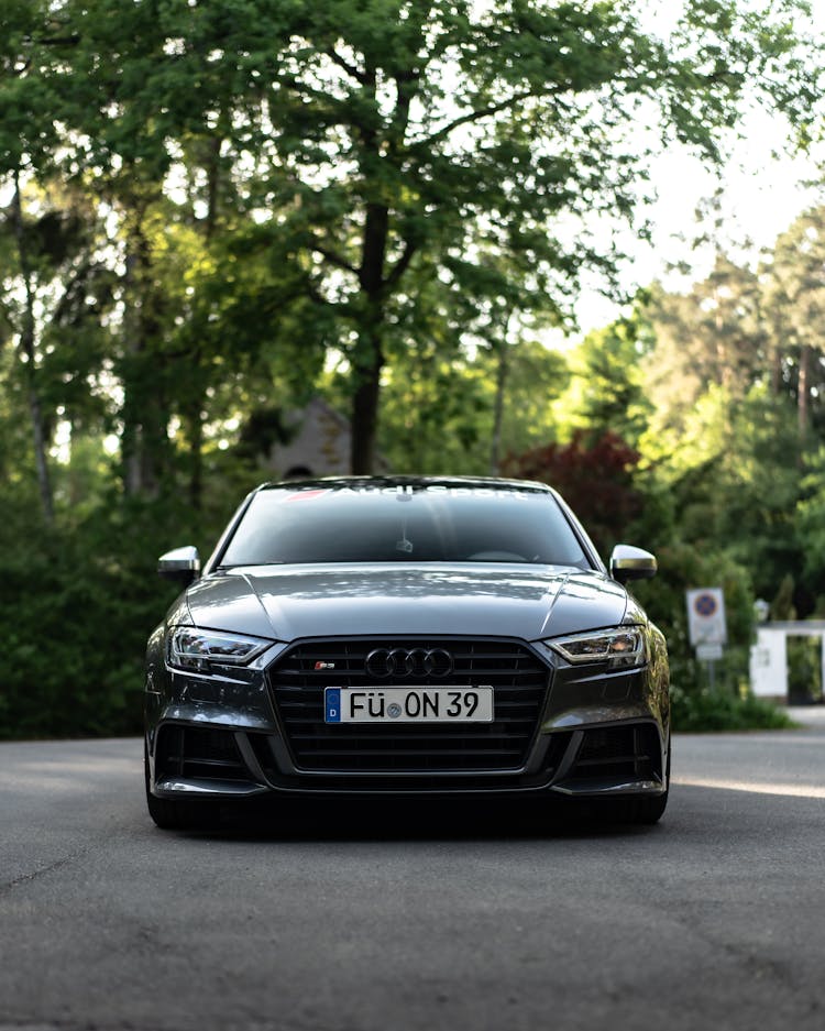 Black Sedan Car Parked On A Concrete Road