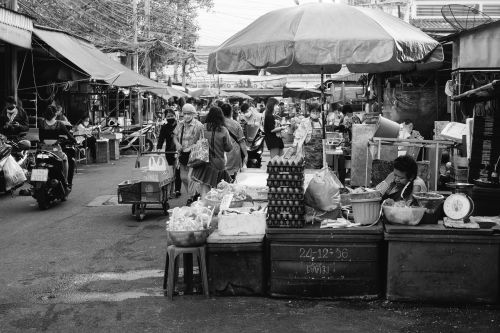 Free Capture of a busy wet market with various stalls and people in a monochrome setting. Stock Photo