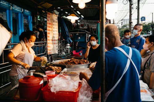 People Buying Food on Street Vendor