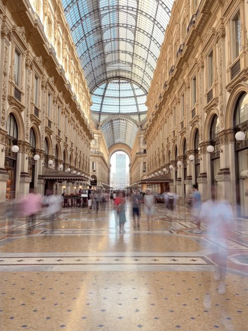 Free Blurred motion photo capturing people in historic Galleria Vittorio Emanuele II, Milan. Stock Photo