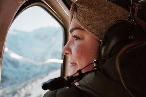 A Woman Looking Through the Plane Window