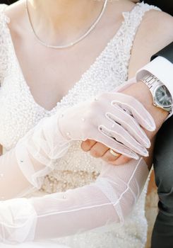 Bride and groom symbolizing love and unity with a close embrace during their wedding day.