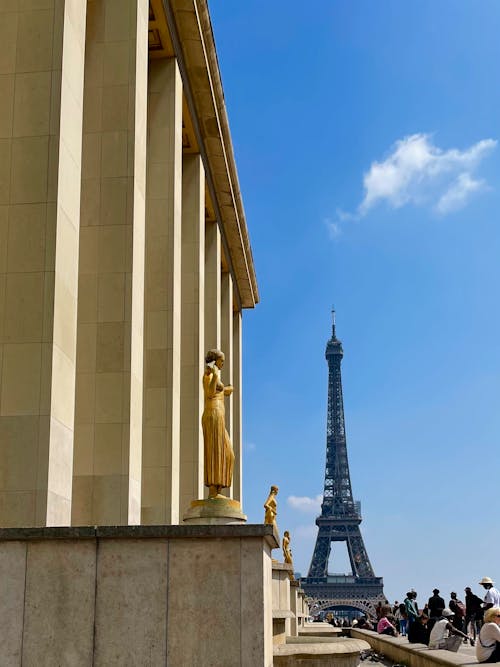 Golden Statues With the Eiffel Tower in the Background