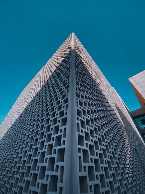Low-Angle Shot of a White Modern Building under the Blue Sky