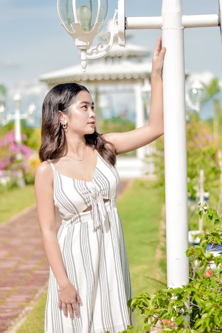 Teenage Girl Holding On A Lamp Post