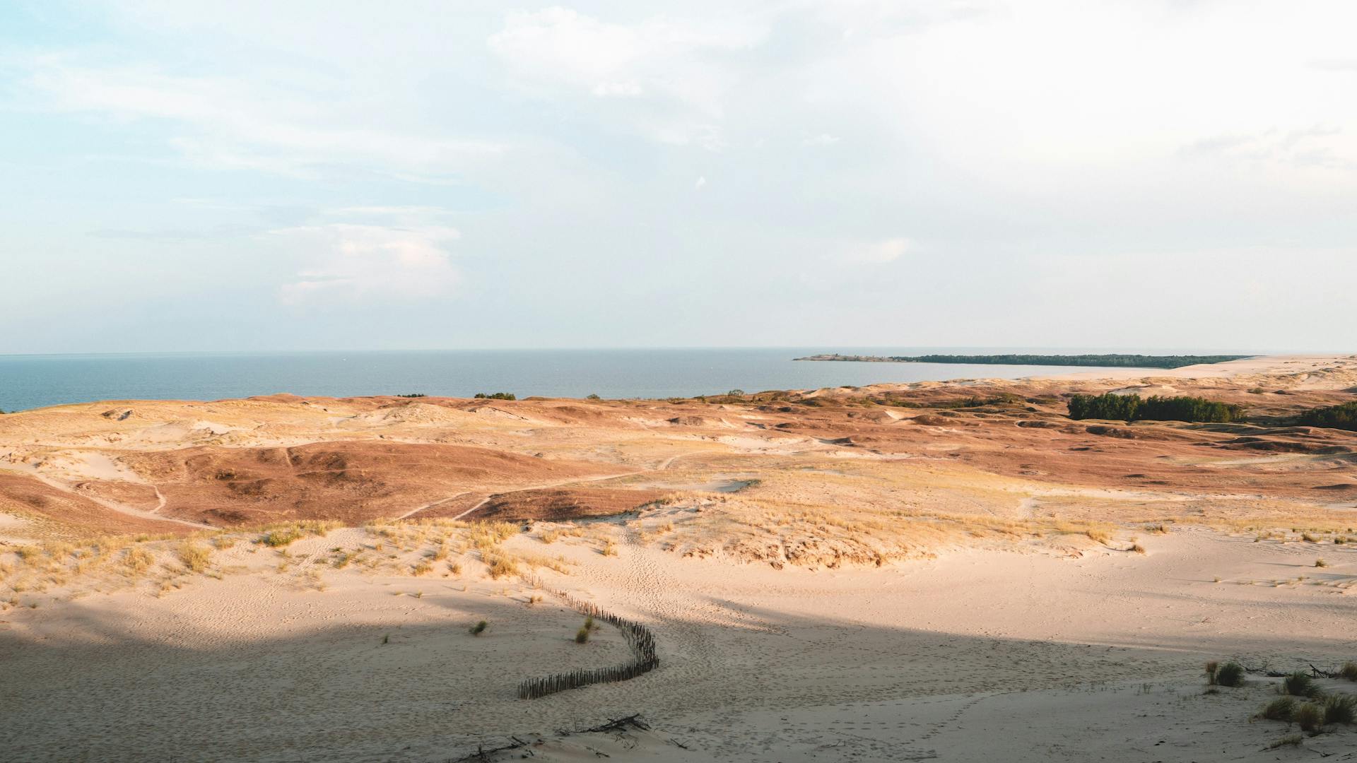 Breathtaking view of the Curonian Spit sand dunes meeting the Baltic Sea.