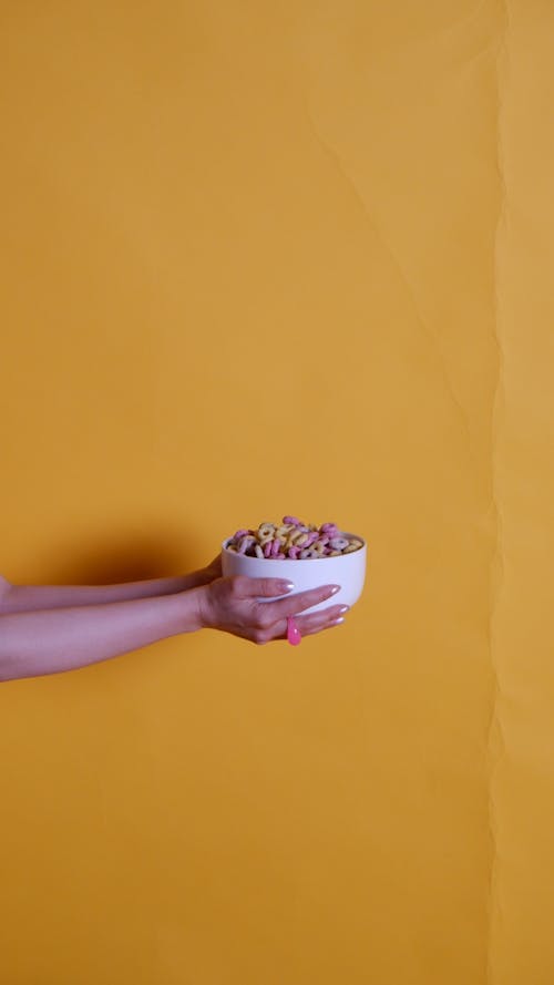 A Person Holding a Bowl of Cereals
