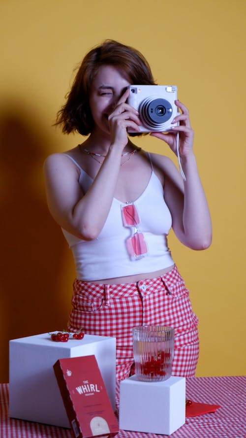 Woman Taking Photo with a Polaroid