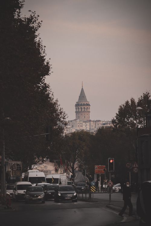 Free View of Galata Tower in the distance with cars and city life at dusk in Istanbul, Turkey. Stock Photo