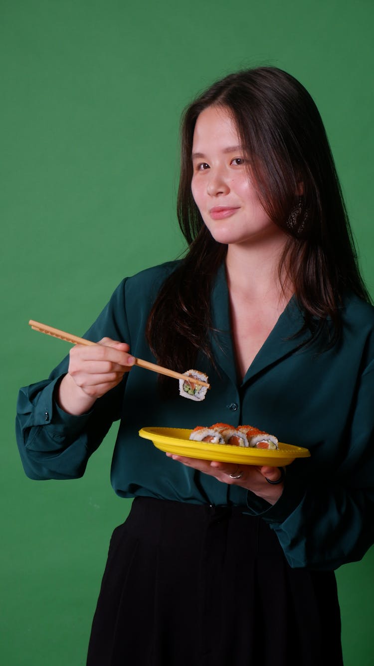 Woman Eating Sushi In Studio